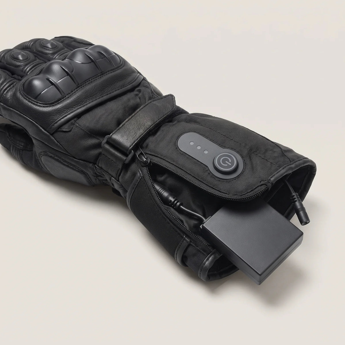 Battery in the gauntlet pocket, next to the button with level lights